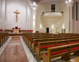 inside-of-a-church-pews-hanging-cross-shiny-aisle